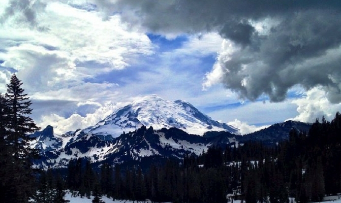 See the craggy peaks of Mount Rainier dusted with snow