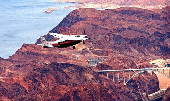 Fly in a private plane over Lake Mead and the Hoover Dam